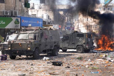 Smoke from fires fills the air as Palestinians clash with Israeli forces in the West Bank city of Nablus, Wednesday, Feb. 22, 2023. (AP)