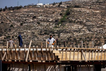 A construction worker stands on a building site in the Jewish settlement of Givat Harel in the Israeli-occupied West Bank, February 22, 2023. (Reuters)