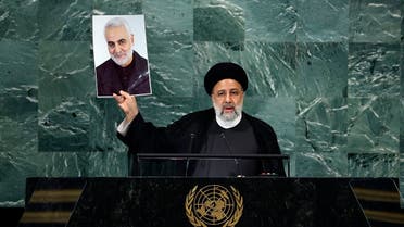 Iranian President Ebrahim Raisi holds up a photo of Quds Force commander Qassem Soleimani, who was killed in a US attack, during his remarks at the 77th session of the United Nations General Assembly (UNGA) at UN headquarters on September 21, 2022 in New York City. (Getty Images via AFP)