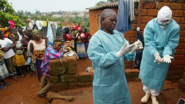 World Health Organization officials examine the home of a suspected Marburg virus victim in the northern Angolan town of Uige on April 19, 2005. (Reuters)