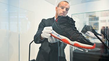 A Sotheby’s staffer checking one of Michael Jordan’s six NBA championship Air Jordan sneakers unveiled at Sotheby’s DIFC Gallery in Dubai on February 28, 2023. (Supplied)