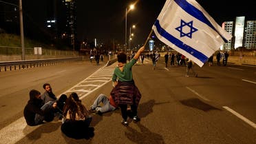 People block a road as they attend a protest against Israel's Prime Minister Benjamin Netanyahu's new right-wing coalition and its proposed judicial changes to reduce powers of the Supreme Court in Tel Aviv, Israel February 25, 2023. (Reuters)