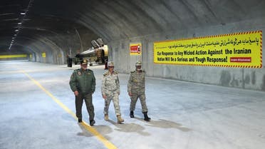 A handout picture provided by the Iranian Army office on February 7, 2023 shows Commander-in-Chief of the Iranian Army Major General Abdolrahim Mousavi (R) and Armed Forces Chief of Staff Major General Mohammad Bagheri (C) visiting Iran's first underground military air base in an undisclosed location. (Photo by Iranian Army office / AFP)