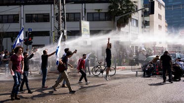 Police scuffle with Israelis blocking a main road to protest against plans by Prime Minister Benjamin Netanyahu's new government to overhaul the judicial system, in Tel Aviv, Israel, Wednesday, March 1, 2023. (AP Photo/Oded Balilty)