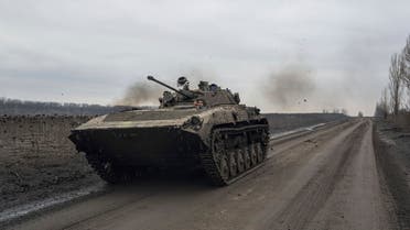 A Ukrainian serviceman drives an APC towards frontline positions near Bakhmut, Ukraine, Wednesday, March 1, 2023. (AP Photo/Evgeniy Maloletka)