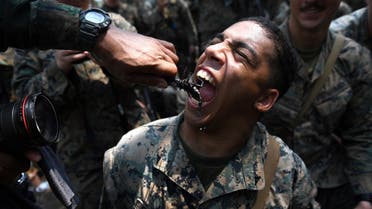  A US Marine eats a scorpion during a jungle survival training with Thai soldiers in the joint 'Cobra Gold' military exercise in Chantaburi province on February 14, 2019. The US and Thailand hold on February 14, the annual joint 'Cobra Gold', the largest US-led military exercises in Asia involving gruelling drills in the Thai jungle, war games, humanitarian assistance and disaster relief exercise. / AFP / Lillian SUWANRUMPHA