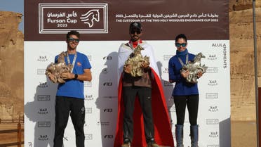 Spain's Omar Blanco (left), Bahrain's Mohammed Hashemi (center), and Spain's Maria Alvarez (right) on the podium after the 2023 Custodian of the Two Holy Mosques Endurance Cup in Saudi Arabia's AlUla. 