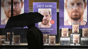 A pedestrian holding an umbrella walks past Waterstones' flagship Piccadilly bookshop advertising the release of Spare by Britain's Prince Harry, Duke of Sussex, in London, on January 10, 2023. (AFP)