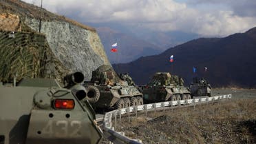 FILE - Russian military vehicles roll along a road towards the separatist region of Nagorno-Karabakh, Friday, Nov. 13, 2020. The United Nations' highest court ordered Azerbaijan on Wednesday, Feb. 22, 2023, to remove a roadblock from the only road between Armenia and the ethnic Armenian Nagorno-Karabakh region in Azerbaijan that has further fueled tensions between the two countries. (AP Photo/Sergei Grit, File)