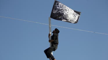 A member of al Qaeda's Nusra Front climbs a pole where a Nusra flag was raised at a central square in the northwestern city of Ariha, after a coalition of insurgent groups seized the area in Idlib province May 29, 2015. (File photo: Reuters)