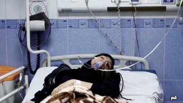 A young woman lies in hospital after reports of poisoning at an unspecified location in Iran in this still image from video from March 2, 2023. (Reuters)