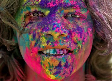 The face of a boy is seen daubed in colours as he takes part in Holi celebrations in Ahmedabad, India, March 18, 2022. (Reuters)