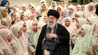 This handout picture provided by the office of Iranian Supreme Leader Ali Khamenei shows him talking with Iranian girls ahead of prayers during a ceremony called ‘Angels celebration’ in the capital Tehran, on February 3, 2023. (Khamenei.ir via AFP)