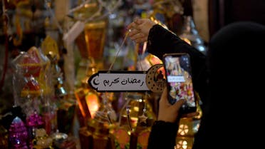 A Saudi woman takes a picture of decorations in the Saudi coastal city of Jeddah on May 3, 2019, ahead of the Muslim holy fasting month of Ramadan. / AFP / Amer HILABI
