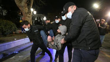 Law enforcement detain a man during a rally against the foreign agents law in Tbilisi, Georgia, March 8, 2023. (Reuters)