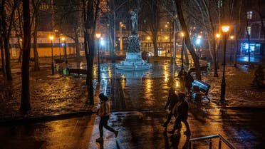 Pedestrians walk through a lighted park in the centre of Kharkiv, on March 7, 2023, amid the Russian invasion of Ukraine. (AFP)