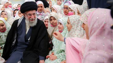 This handout picture provided by the office of Iranian Supreme Leader Ali Khamenei shows him talking with Iranian girls ahead of prayers during a ceremony called ‘Angels celebration’ in the capital Tehran, on February 3, 2023. (Khamenei.ir via AFP)
