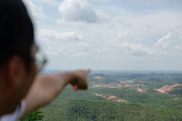 Cahyadi Indrananto, Chief Knowledge Management of Nusantara National Capital (IKN), points at the core goverment area construction of Indonesia's new capital, in Sepaku, East Kalimantan province, Indonesia, March 8, 2023. (Reuters)