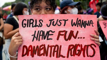 A Filipino activist holds a placard during a protest on Women’s Day, in Manila, Philippines, on March 8, 2023. (Reuters)