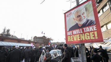A poster showing the late Iranian commander Qasem Soleimani hangs on a pole as demonstrators gather for a protest against cartoons of the Islamic Republic’s supreme leader published by French satirical weekly Charlie Hebdo, outside the French embassy in Iran’s capital Tehran on January 8, 2023. (AFP)