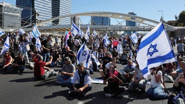 Israelis block a road as they protest against the government's controversial judicial reform bill in Tel Aviv on March 9, 2023. (AFP)