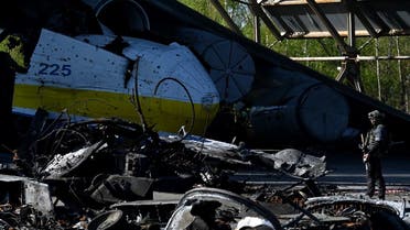 A serviceman stands guard at a destroyed Ukrainian Antonov An-225 Mriya cargo aircraft amid the Russian invasion of Ukraine, at airport of town of Hostomel, in Kyiv region, on May 5, 2022. (AFP)