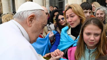 This photo taken and handout on March 8, 2023 by The Vatican Media shows Pope Francis meeting with a group of Ukrainians from Caritas Pescara, during the weekly general audience on March 8, 2023 at St. Peter's square in The Vatican. (Handout/Vatican Media/AFP)