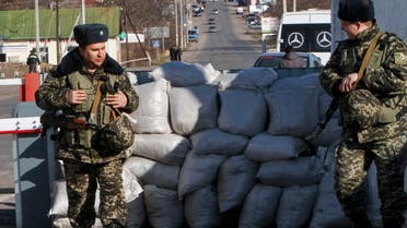Ukrainian border guards stand at a checkpoint at the border with Moldova breakaway Transnistria region, near Odessa March 13, 2014. REUTERS/Yevgeny Volokin (UKRAINE - Tags: POLITICS CIVIL UNREST MILITARY)