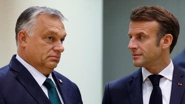 France's President Emmanuel Macron and Hungarian Prime Minister Viktor Orban attend a European Union leaders' summit in Brussels, Belgium October 21, 2022. (Reuters)