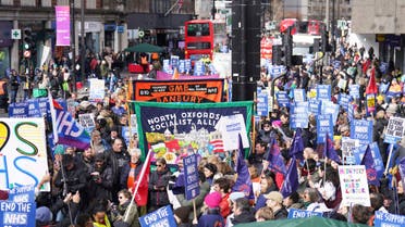 People gather in London, Saturday March 11, 2023, ahead of a Support the Strikes march in solidarity with nurses, junior doctors and other NHS staff following recent strikes over pay and conditions. (James Manning/PA via AP)