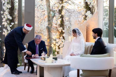 A handout picture released by the Jordan's Royal Palace shows King Abdullah II (seated L) testifying at the wedding of his eldest daughter Princess Iman and Jameel Alexander Thermiotis (R) in Amman on March 12, 2023. (AFP)