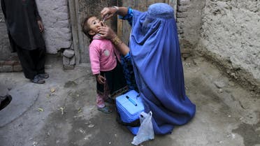 A child receives a polio vaccination during an anti-polio campaign on the outskirts of Jalalabad, Afghanistan, December 1, 2015. (Reuters)