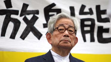 Japanese Nobel literature prize winner Kenzaburo Oe sits in front of a banner reading radiation during an anti-nuclear gathering in Tokyo, Japan September 19, 2011. (Reuters)