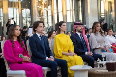A handout picture released by Jordan's Royal Palace shows Queen Rania al-Abdullah with her children: Princess Salma (L), Prince Hashem (2nd L) and Crown Prince Hussein (2nd R) with his Saudi fiancée Rajwa Khaled bin Musaed bin Saif (C) during the wedding ceremony of her eldest daughter Princess Iman and Jameel Alexander Thermiotis in Amman on March 12, 2023. (AFP)