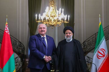 A handout picture provided by the Iranian presidency shows Iran’s President Ebrahim Raisi (R) and Belarus President Alexander Lukashenko during a ceremony to sign a memorandum of understanding in Tehran on March 13, 2023. (AFP)