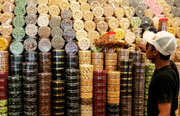 A trader uses a feather duster to clean containers of local pastries at a Ramadan bazaar stall in Kuala Lumpur September 6, 2009. (Reuters)