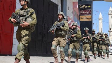 Israeli troops patrol in the occupied-West Bank town of Huwara, on March 17, 2023. (Photo by JAAFAR ASHTIYEH / AFP)