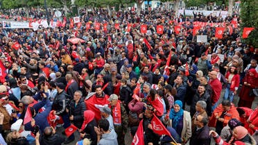 Supporters of Tunisia's President Kais Saied carry national flags and banners during a rally to demonstrate their support for him after a crackdown on opponents accused of treason and corruption, and to reject what they call foreign interference, in Tunis, Tunisia March 20, 2023. (Reuters)