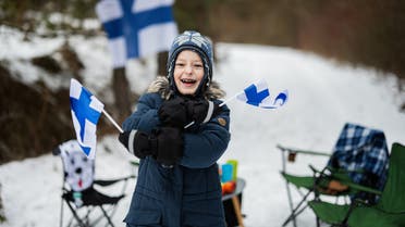 Finnish boy with Finland flags on a nice winter day. Nordic Scandinavian people. stock photo