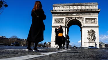 Chinese tourists take pictures in the Champs Elysees Avenue near the Arc de Triomphe in Paris, France, March 14, 2023. (Reuters)