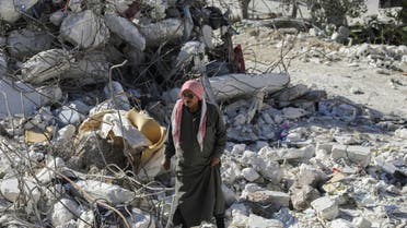 Fadel El Jaber, stands on rubble of the building his son lived with his family, that collapsed from last month's deadly earthquake in the town of Salqin, Syria March 10, 2023. (Reuters)