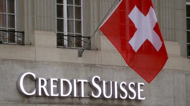 Switzerland's national flag flies above a logo of Swiss bank Credit Suisse in front of a branch office in Bern, Switzerland November 29, 2022. (Reuters)