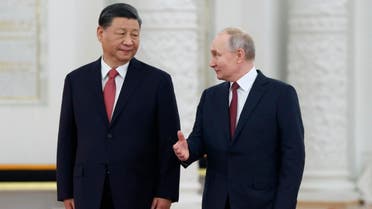 Russian President Vladimir Putin, right, speaks to Chinese President Xi Jinping as they attend an official welcome ceremony at The Grand Kremlin Palace, in Moscow, Russia, Tuesday, March 21, 2023. (AP)