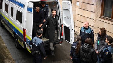 Andrew Tate (C-L, in the police car) and his brother Tristan Tate (C-R, stepping out of the car) arrive at The Court of Appeal in Bucharest, Romania, on February 27, 2023. (AFP)