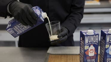 A staff pours Nestle new product, a milk alternative made from yellow peas called “Wunda,” into a glass during a media presentation at Nestle research center at Verschezles-Blanc in Lausanne, Switzerland. (Reuters)
