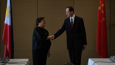 Philippines Undersecretary for Bilateral Relations and ASEAN Affairs of the Department of Foreign Affairs Theresa Lazaro shake hands with China's Vice Foreign Minister Sun Weidong during the opening session of the Philippines-China Foreign Ministry consultation meeting at a hotel in Manila, Philippines, March 23, 2023 (Reuters)