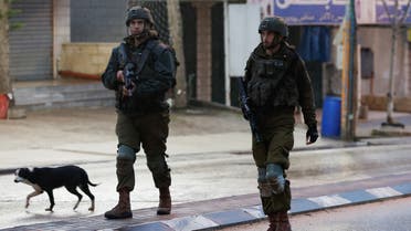 Israeli troops stand guard at the scene of a shooting, in Huwara, in the Israeli-occupied West Bank, March 19, 2023. REUTERS/Mohamad Torokman