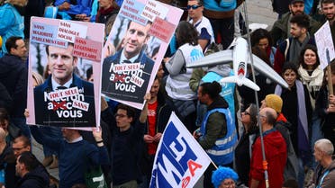 Protesters hold placards with a portrait of French President Emmanuel Macron during a demonstration as part of the ninth day of nationwide strikes and protests against French government's pension reform, in Paris, France, March 23, 2023. REUTERS/Yves Herman