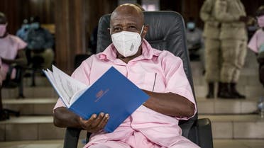 Paul Rusesabagina looks on as he sits with some of his coaccused at the Supreme Court in Kigali on February 17, 2021 where he is facing charges related to their association with Mouvement Rwandais pour le changement démocratique (MRCD) and its armed wing FLN. (AFP)