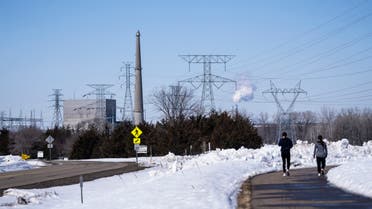 People walk on a trail at the Montissippi County Park near the Xcel Energy Monticello Generating Plant, a nuclear power plant, in Monticello, Minn., on Friday, March 24, 2023. (AP)
